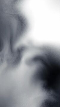 Abstract swirling patterns in motion sequence. Dynamic smoke-like flows evolving from formation to dispersion. Artistic visualization of fluid turbulence concept. Vertical video