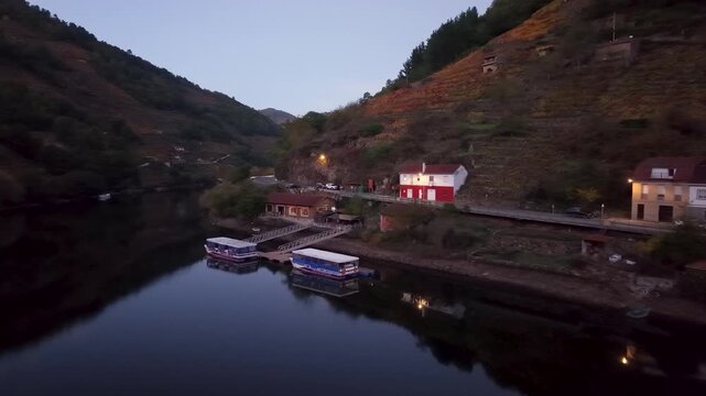 Belesar village with autumn vineyards reflecting in the tranquil mi&ntilde;o river