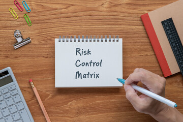 There is notebook with the word Risk Control Matrix. It is as an eye-catching image.