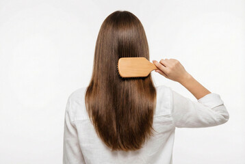 Woman Meticulously Organizing Her Shiny Brown Hair During Work Session