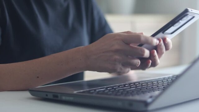 Cybersecurity, Cyber security 2FA login concept. Businesswoman working on laptop logging in on smartphone and modern device. Concept of remote work, freelancing, training, banking, online shopping.