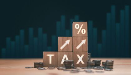 Tax and interest rate growth concept. Wooden blocks showing TAX, arrows, and percentage symbol among coins. Financial planning, increasing rates, government policy, business costs and economic impact.