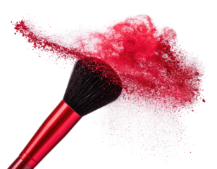 Cosmetic brush creating a burst of red powder on a transparent background