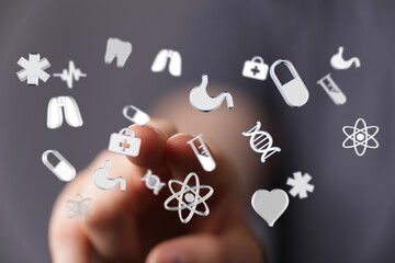 Healthcare symbols floating above a hand, representing medicine, science, and well-being. Ideal for medical pr