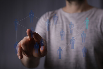 Person interacting with network concept with a fingertip, showing connection and collaboration with a digital i