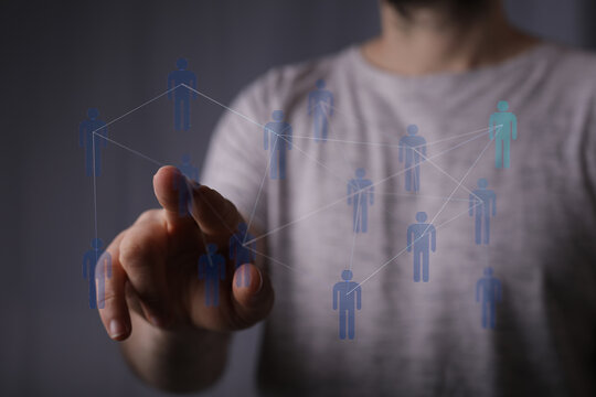 Person interacting with network concept with a fingertip, showing connection and collaboration with a digital i - Powered by Adobe