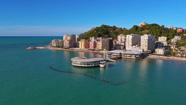 Aerial drone view of the iconic circular Rotonda building extending over the turquoise waters of the Adriatic Sea in Durres, Albania