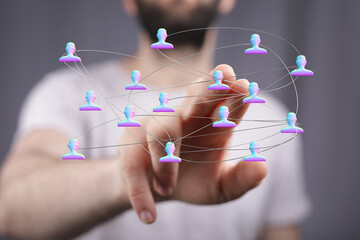 Abstract visual representation of network. Hand pointing to human icons connected by lines. Business networking. Teamwork and concept of digital