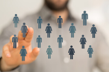 Hand pointing at people icons, symbolizing social networking, connection, teamwork, and global communication.