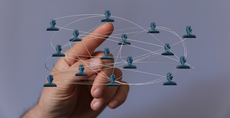 Hand pointing at connected people icons illustrating digital communication, global network, and social connections. Concepts of teamwork and col