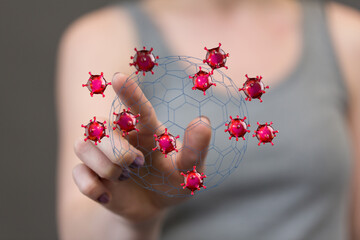 Hand touching a sphere of coronavirus particles representing control, protection, and the fight...