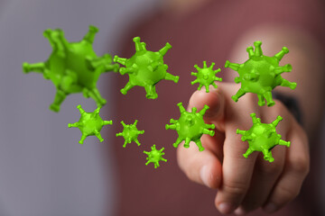 Abstract illustration of a hand pointing at 3D rendered coronavirus to express concepts such as disease, risk,