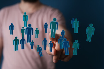 Hand interacting with digital human icons, symbolizing teamwork, collaboration, and unity within a...