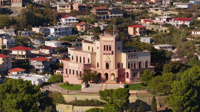 Aerial drone view of King Zog's Villa palace sitting on a hill overlooking the Durres, Albania