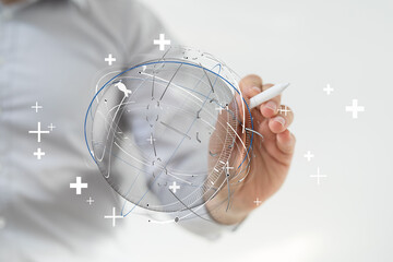 Concept of global network and communication. Man hand pointing at world globe with digital pen. Symbol of international business and technology.