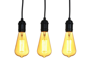 Three glowing vintage filament light bulbs hanging against a pure black background