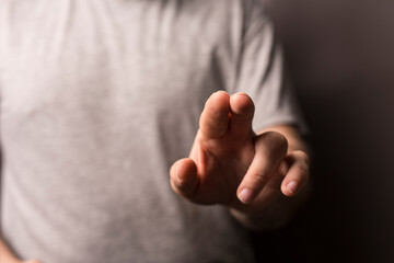 Obraz premium Close up of a hand pointing or touching with a blurred background. Perfect for concepts of touch, interaction, o