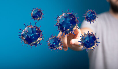 An artistic and conceptual image of the coronavirus model being touched by a hand, symbolizing the dangers tha