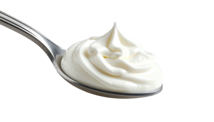 A close-up view showing a spoon filled with swirls of creamy white, thick food