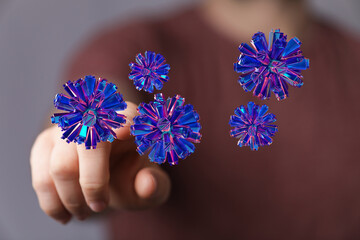 Artistic rendering of a digital abstract virus being interacted with by a human hand, representing...