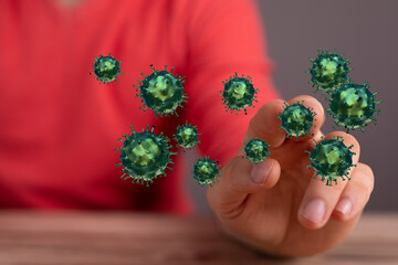Conceptual image of a hand interacting with digital coronavirus molecules, representing health, science, and m