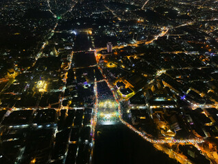 Aerial Night View of City Lights and Urban Streets. A Drone night view of Aleppo, Syria showing illuminated streets, dense residential areas, and major traffic routes under the night sky. 