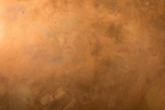 Close-up of a weathered copper surface, ideal for backgrounds and textures. Perfect for adding a touch of warm