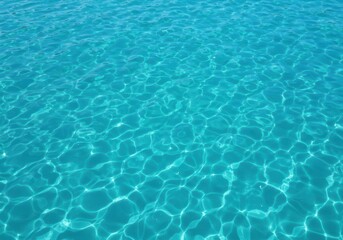Fototapeta premium A vibrant, clear blue texture of seawater ripples under bright sunlight, symbolizing purity, ocean travel, and natural beauty ,sea ,reflection ,sunlight