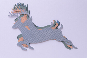 staggered pile of machine-cut silhouettes of reindeer shapes