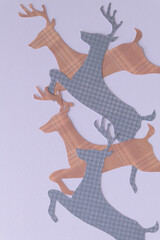 leaping reindeer shapes machine-cut from gray and brown paper with plaid pattern