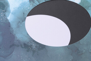 marbled paper with oval cutouts