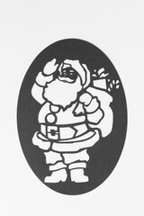 black and white stencil of Santa Claus machine-cut from paper