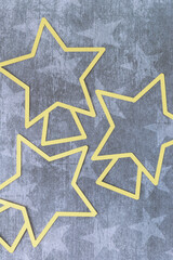 yellow paper star outlines on navy blue paper with stars