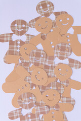 layered pile of machine-cut paper ginger bread men
