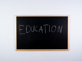 Chalkboard showing EDUCATION concept on black background representing schooling, knowledge and learning process