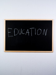 Chalkboard showing EDUCATION concept written vertically representing teaching, learning and academic development