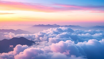 Aerial view showcases layered mountain ranges partially shrouded in fluffy clouds, bathed in hues of pink, orange, and blue