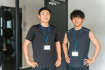 Sports gym, trainer in training gym, male instructor staff