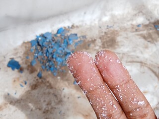 Fototapeta premium Microplastic particles stick to fingers
