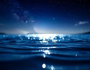 Deep blue image showcasing ocean surface under a starlit night sky, moonlit reflection, dark color scheme