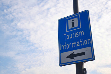 Tourism information sign points left near public area