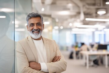 Naklejka premium Confident Indian Mature Businessman Standing in Modern Office
