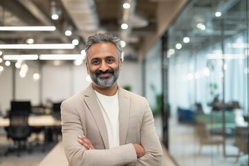 Fototapeta premium Confident Indian Mature Businessman Standing in Modern Office