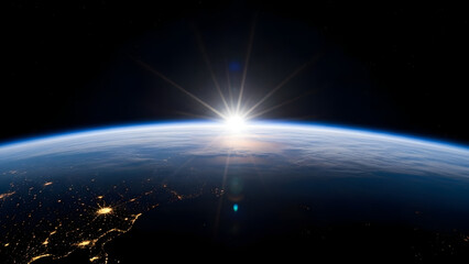 Stunning sunrise over Earth's horizon in space with city lights