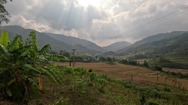 Sunbeams over terraced fields and mountains in Binh Lieu, Vietnam. Panning footage.
