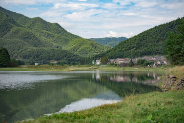 Fototapeta premium Rural Lake Reflections Under Blue Sky And Clouds