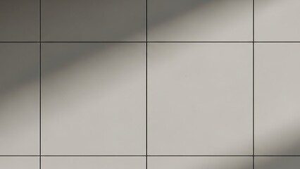 Close-up of a gray tiled wall with shadows cast across it in a geometric pattern.