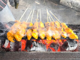 Chicken Satay Cooking Over Charcoal Grill