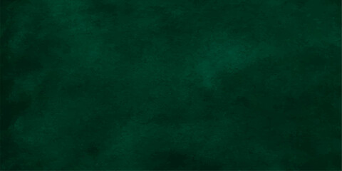 A blank green chalkboard backdrop with a vintage grunge texture and aged paper pattern creates a rough dark wall material for an empty old canvas design © Graph Rover