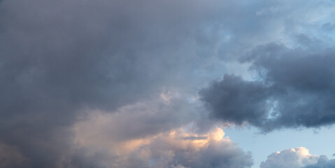 Dramatic storm clouds for the background. Isolated summer storm clouds before a thunderstorm. Dark storm clouds before the rain. Bad weather. A heavenly landscape of clouds in the sky on a rainy day.